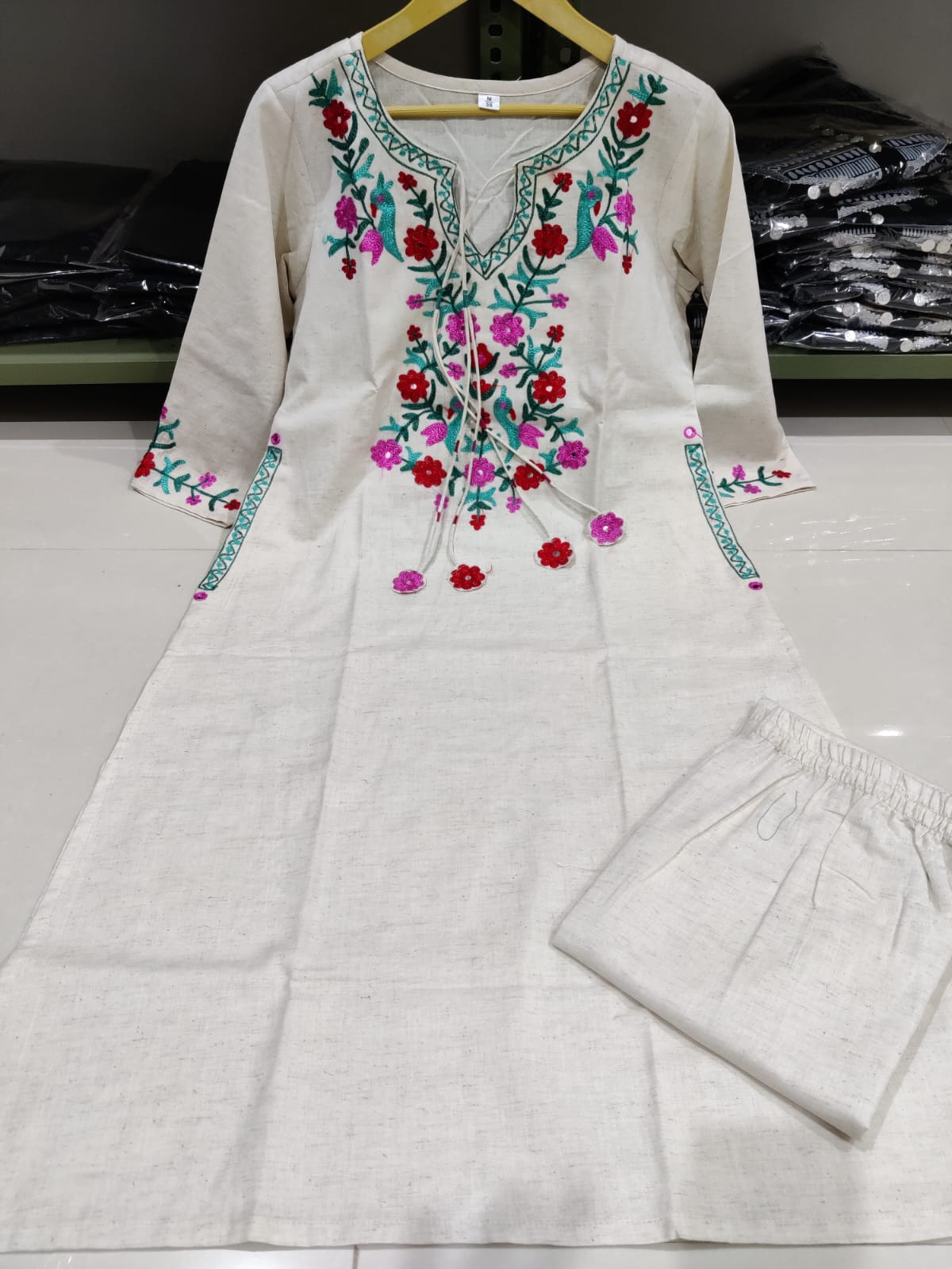 Get your hands on our beautiful off-white kurti with intricate thread aari work detailing in bright tone perfect for any auspicious occasion. (SWSK27)