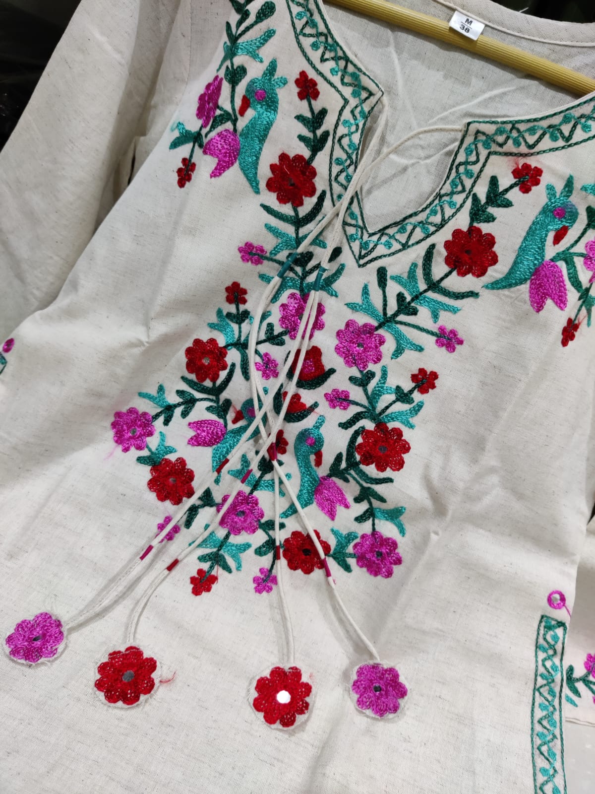 Get your hands on our beautiful off-white kurti with intricate thread aari work detailing in bright tone perfect for any auspicious occasion. (SWSK27)